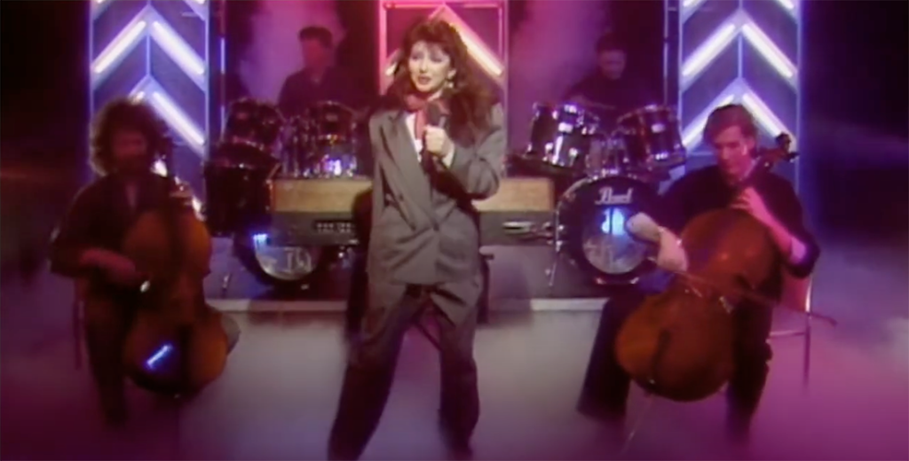 Kate performs Hounds of Love on TOTP - flanked by Paddy Bush (left) and Jonathan Williams (right)