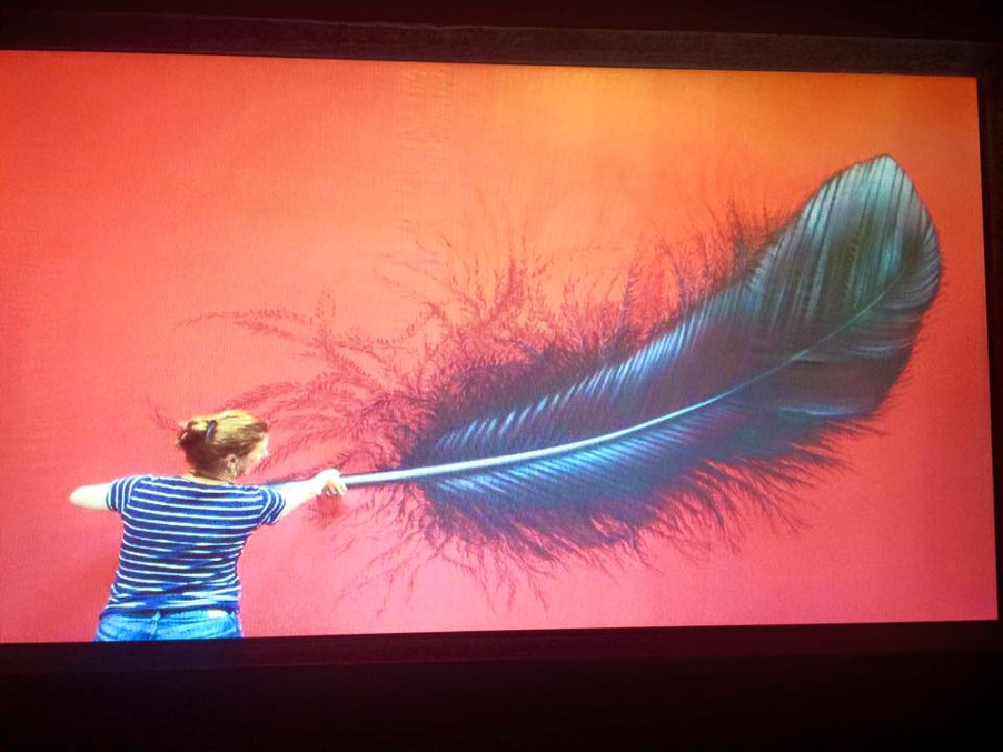 Belinda Clisham paints the Silk feather curtain that dropped over the stage during the interval – signalling A Sky of Honey was to come next – Before The Dawn (2014)